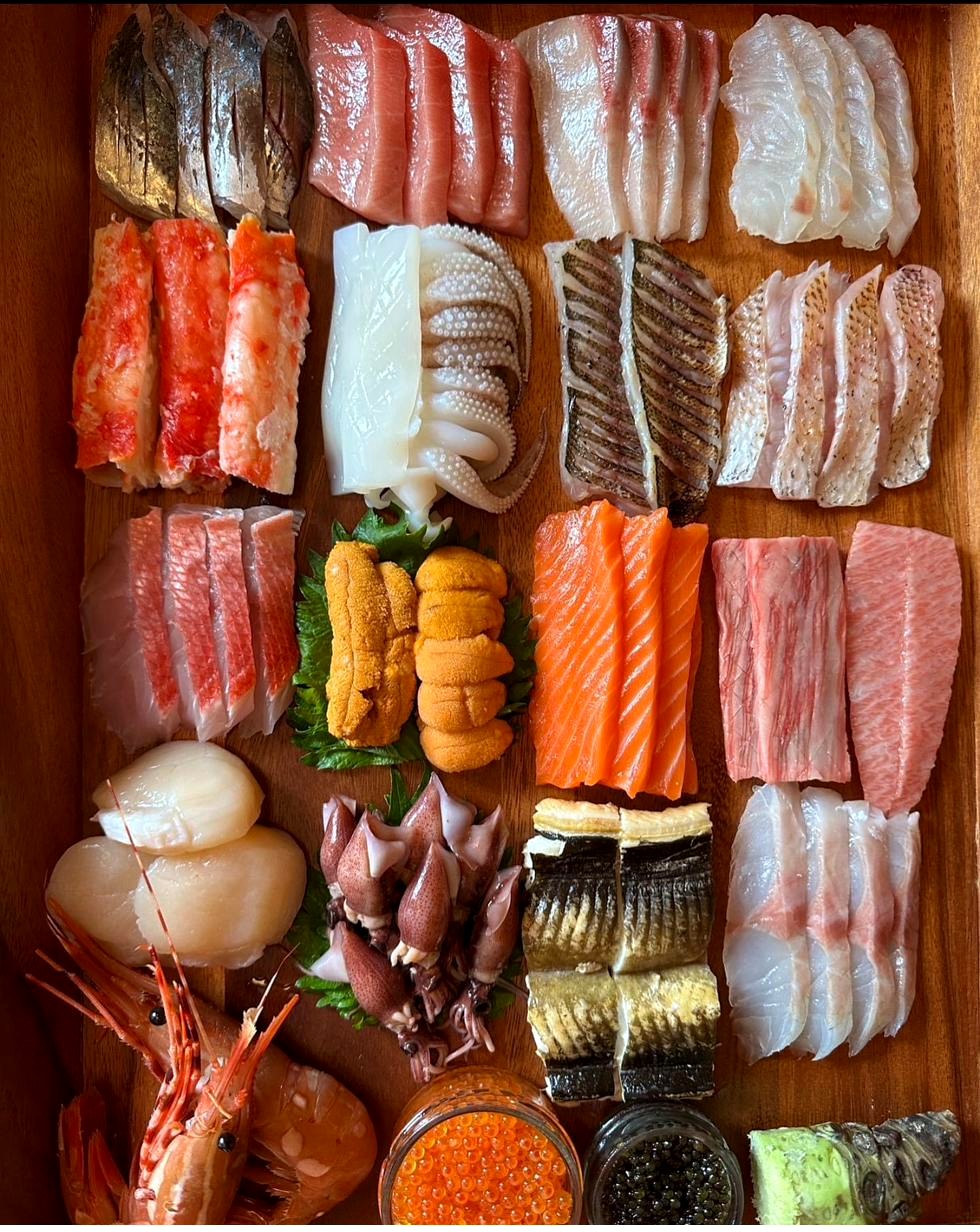 Sushi and sashimi combination platter with tuna, salmon, eel, snapper, shrimp and California rolls